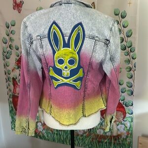 Upcycled denim jacket in a fun blue pink and yellow layer. A little bit rebel.